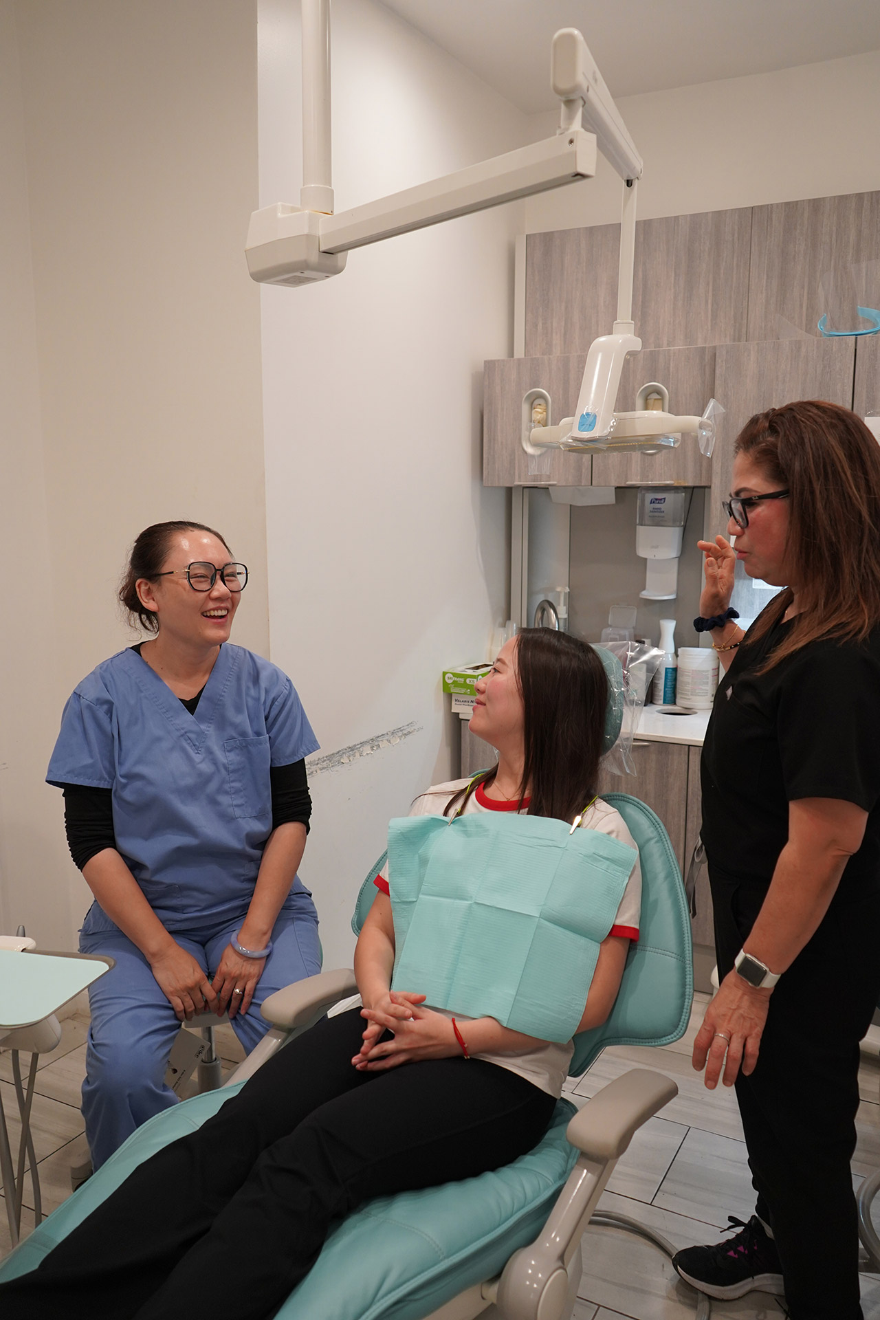 Dental staff providing patient education about oral health and treatment options.