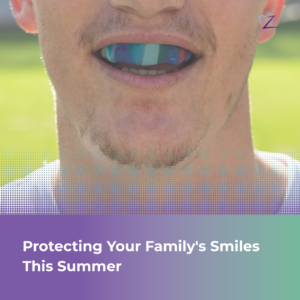 A smiling young athlete wearing a custom sports mouthguard on a sunny Tracy baseball field, representing pediatric dental safety and summer protection.